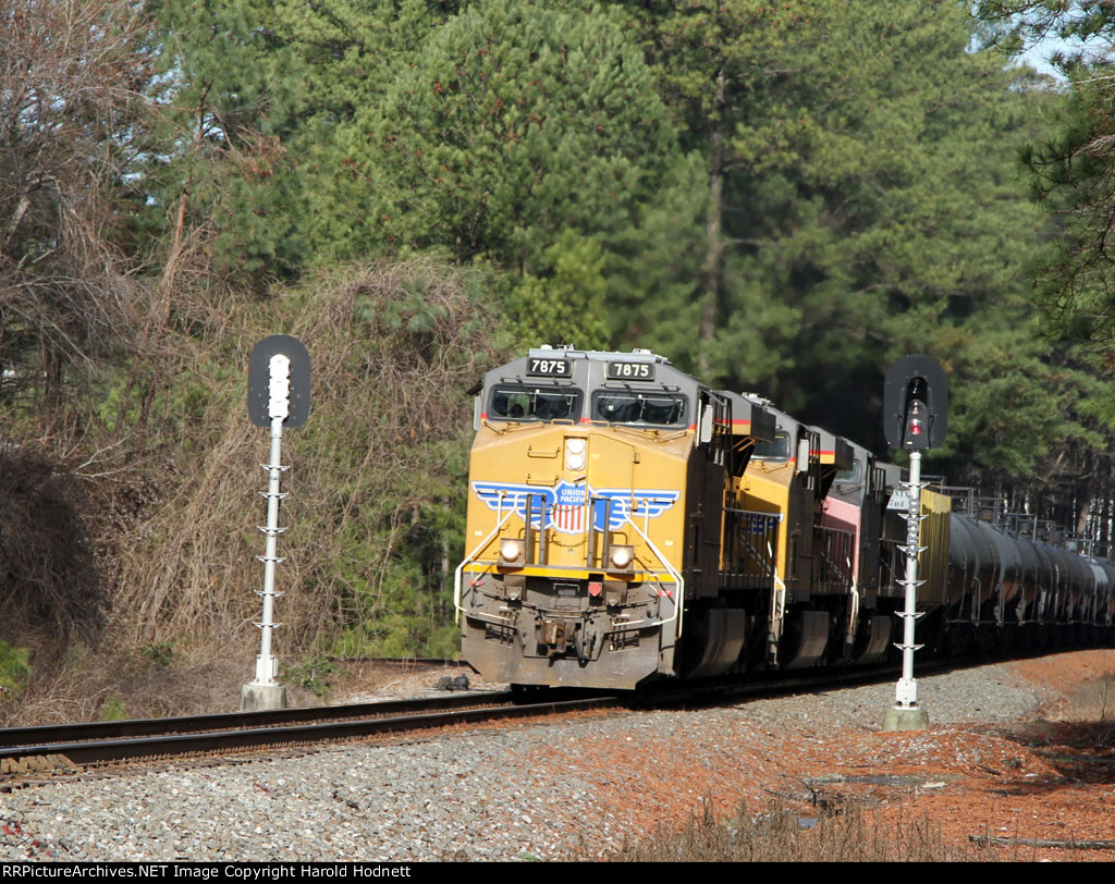 NS train 64D, led by UP 7875, splits the signals